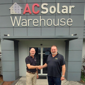 MD of AC Solar Warehouse shaking hands with REC rep.